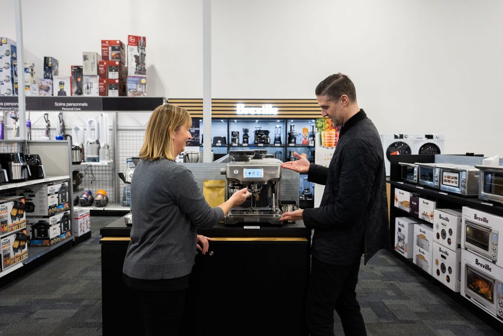 A Breville Product Specialist showing someone a machine.